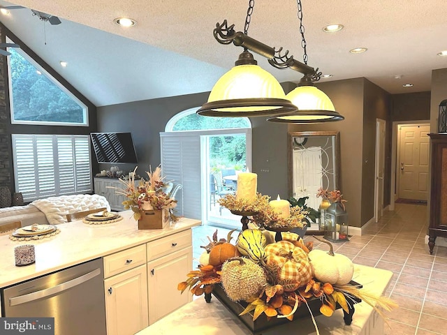 kitchen with lofted ceiling, light tile flooring, dishwasher, and a wealth of natural light