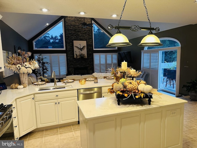 kitchen with white cabinetry, a fireplace, sink, and light tile floors