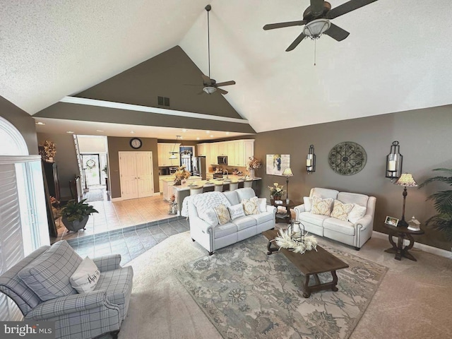 living room with high vaulted ceiling, ceiling fan, and light tile flooring