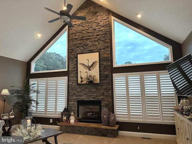 living room with a textured ceiling, high vaulted ceiling, and a fireplace