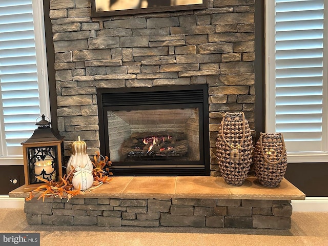 interior details featuring a stone fireplace