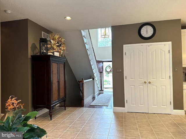 entryway featuring plenty of natural light and light tile floors