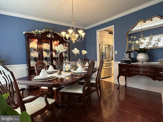 dining space with an inviting chandelier, crown molding, and dark hardwood / wood-style flooring