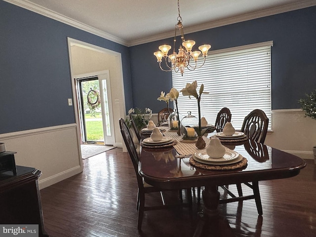 dining room with a notable chandelier, crown molding, and dark wood-type flooring