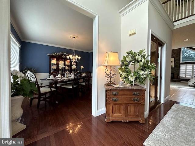 dining room featuring dark tile flooring, ornamental molding, and a chandelier