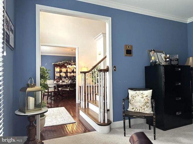 living area with crown molding, an inviting chandelier, and dark colored carpet