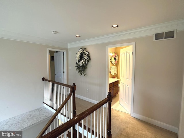 corridor featuring light carpet and ornamental molding