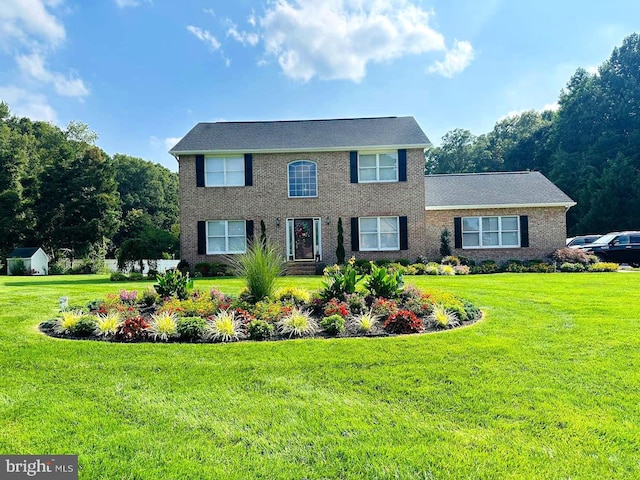 colonial inspired home with a front lawn