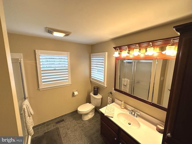 bathroom featuring tile flooring, toilet, and vanity with extensive cabinet space