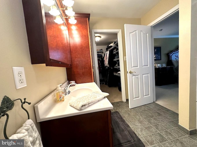 bathroom with an inviting chandelier, ornamental molding, tile flooring, and vanity