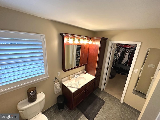 bathroom featuring tile flooring, large vanity, and toilet