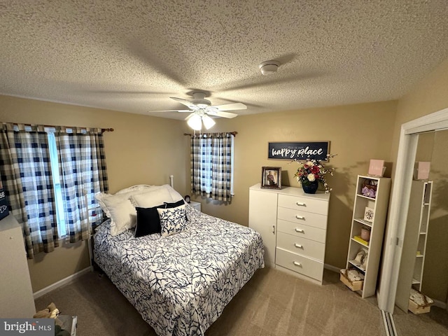 carpeted bedroom with ceiling fan and a textured ceiling