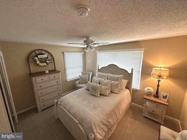 carpeted bedroom with ceiling fan and a textured ceiling