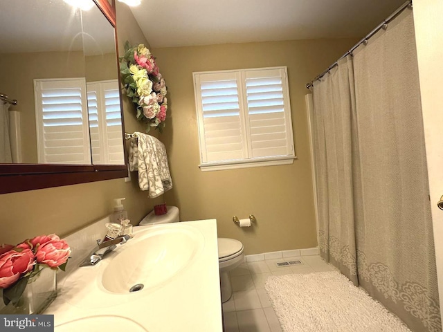 bathroom with toilet, tile flooring, and sink