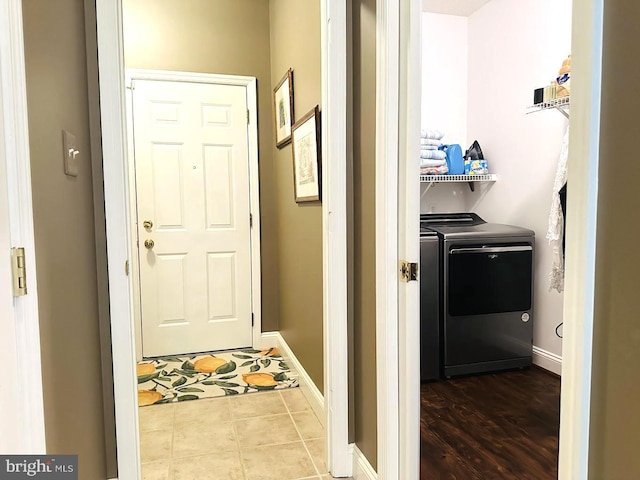 doorway with tile floors and washer and dryer