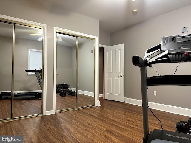 workout area featuring dark wood-type flooring