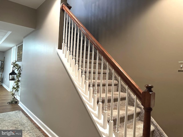 staircase featuring hardwood / wood-style floors