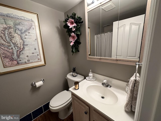 bathroom with vanity with extensive cabinet space and toilet