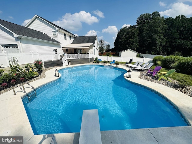 view of pool featuring a diving board