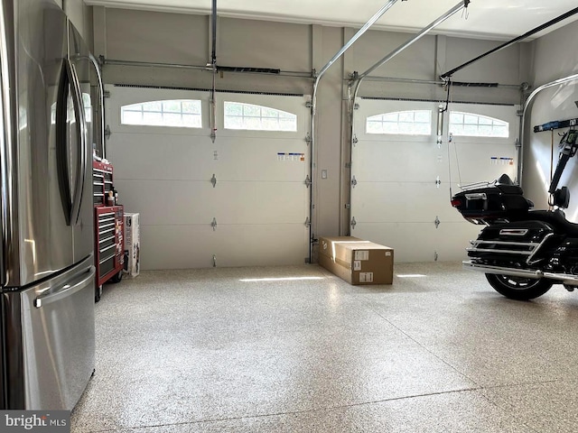 garage with stainless steel refrigerator