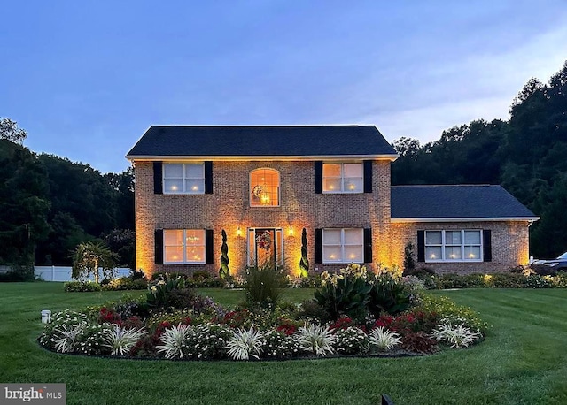 colonial-style house with a lawn