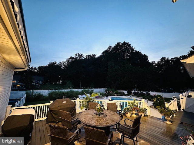 deck featuring a fenced in pool