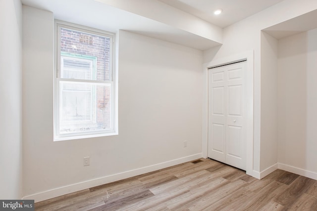 spare room featuring light hardwood / wood-style flooring