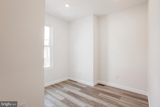 unfurnished room with light hardwood / wood-style flooring