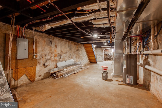 basement featuring water heater and electric panel