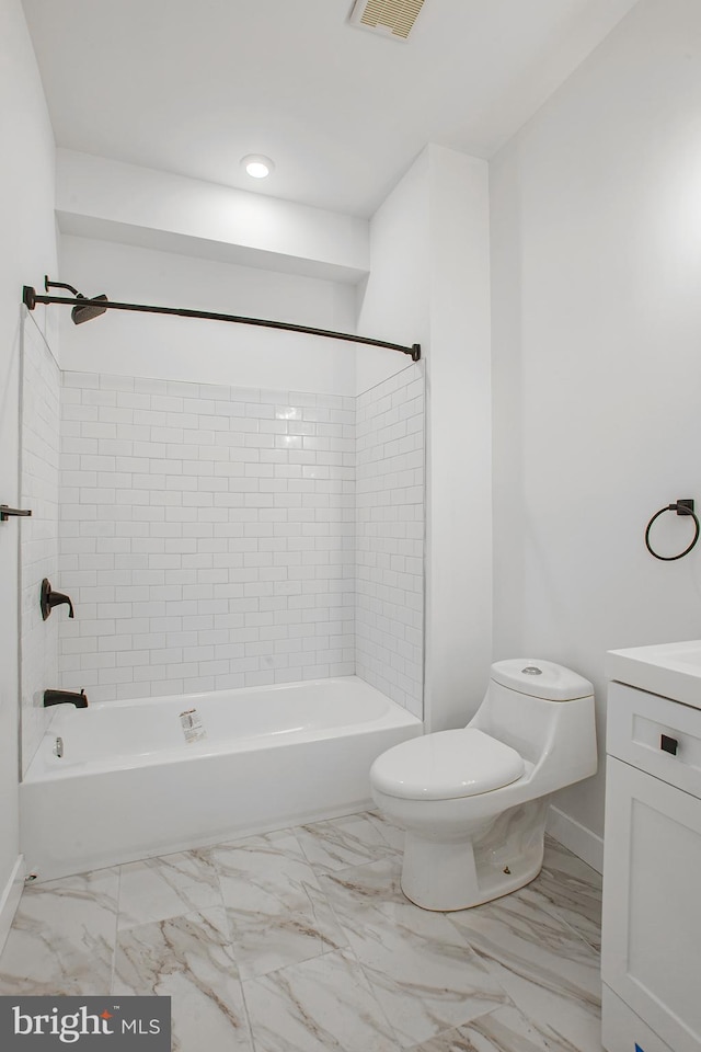 full bathroom with toilet, vanity, and tiled shower / bath