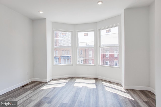 unfurnished room with light hardwood / wood-style floors