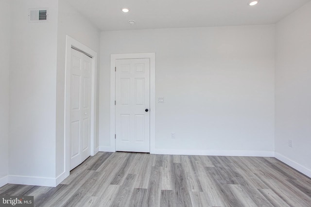 spare room featuring light hardwood / wood-style floors