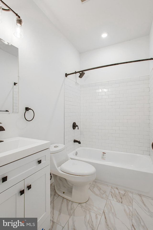 full bathroom featuring vanity, toilet, and tiled shower / bath