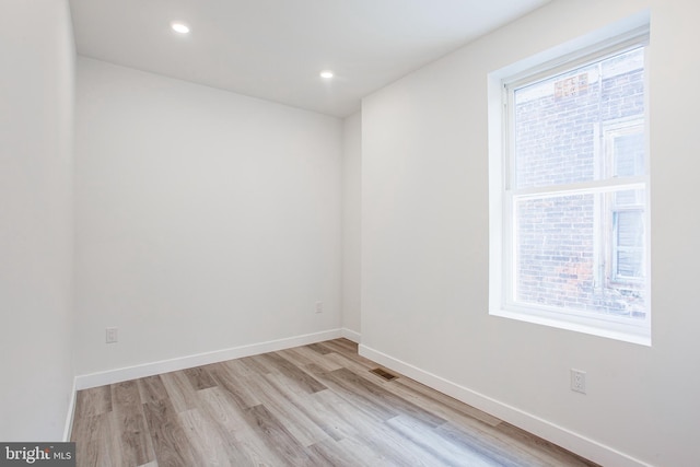 spare room featuring light hardwood / wood-style floors