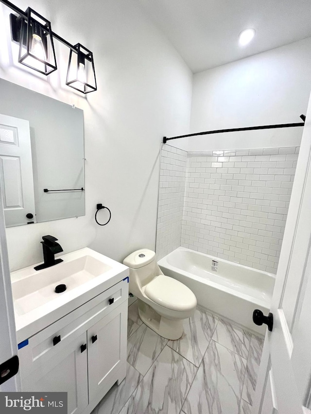 full bathroom featuring toilet, vanity, and tiled shower / bath