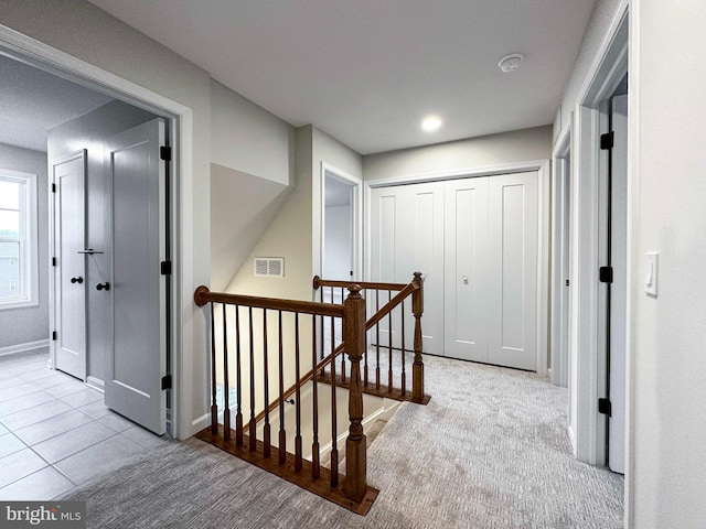 corridor featuring light colored carpet