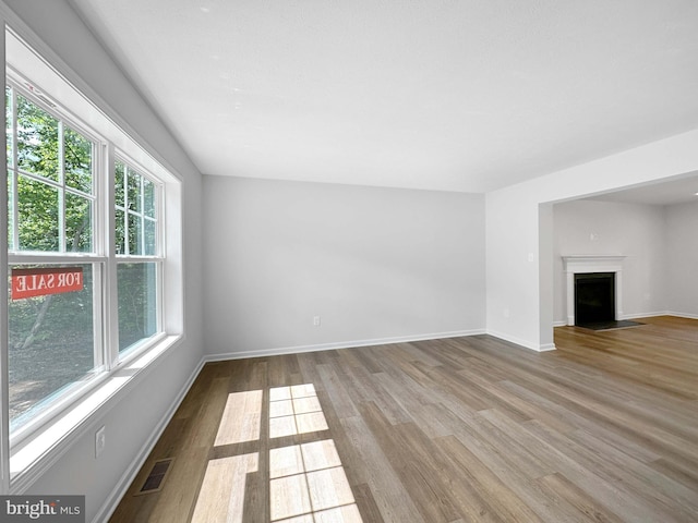 unfurnished living room with hardwood / wood-style floors