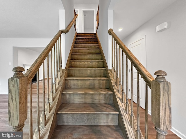 staircase with hardwood / wood-style floors