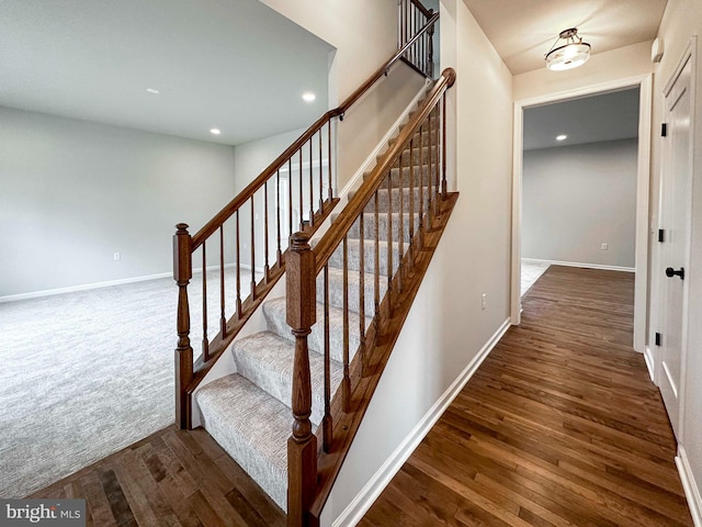 stairs with hardwood / wood-style floors