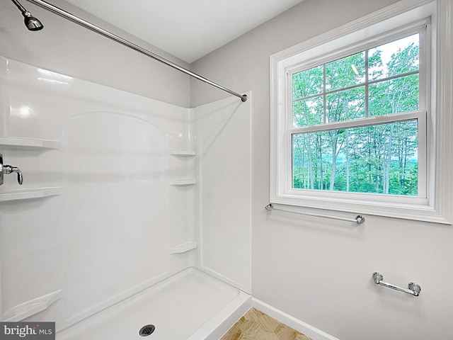 bathroom with a healthy amount of sunlight and walk in shower