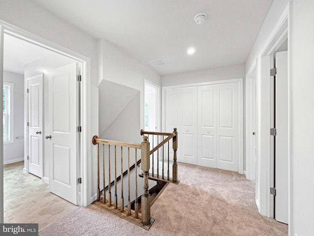 hallway featuring light carpet