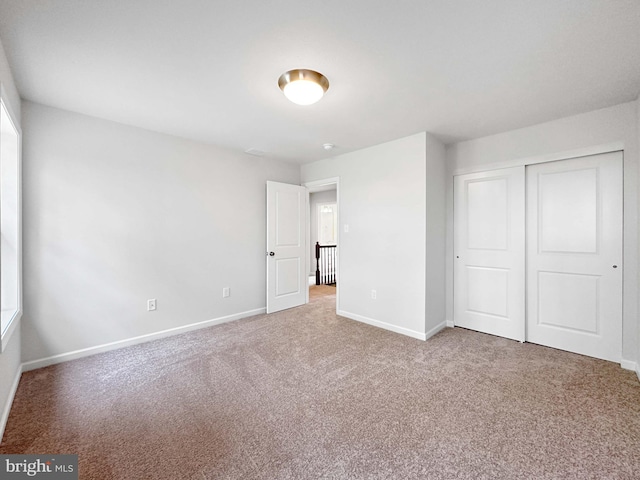 unfurnished bedroom featuring carpet floors and a closet