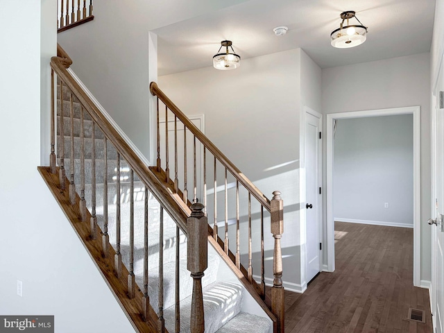 stairs featuring wood-type flooring