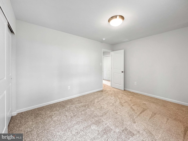 unfurnished bedroom with a closet and carpet floors