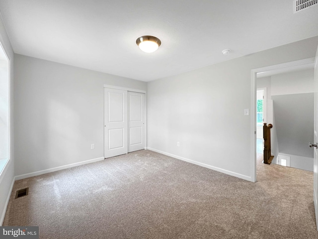 unfurnished bedroom featuring a closet and carpet floors