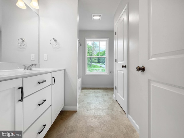 bathroom featuring vanity and independent shower and bath