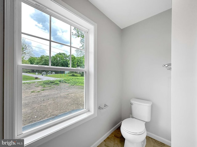 bathroom featuring toilet and a wealth of natural light