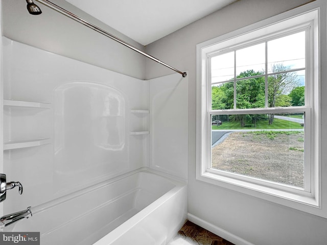 bathroom featuring shower / bathing tub combination and plenty of natural light