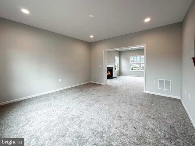 unfurnished living room featuring carpet flooring