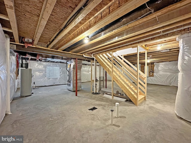 basement featuring heating unit and water heater